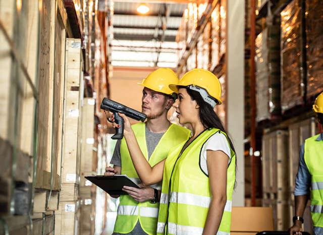 two persons controlling stock in warehouse