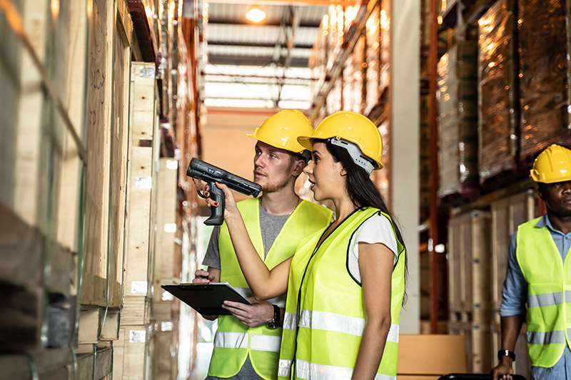 two persons controlling stock in warehouse